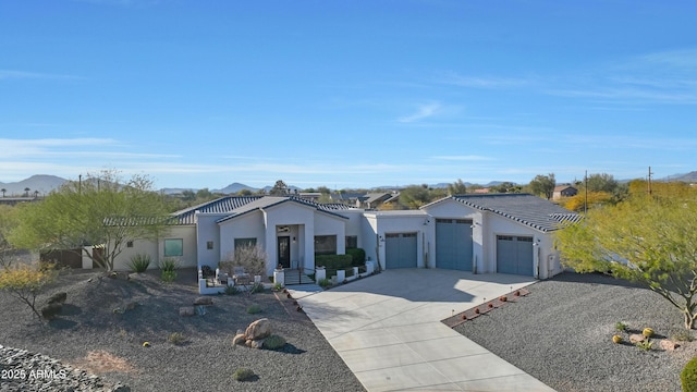 view of front facade with a mountain view and a garage