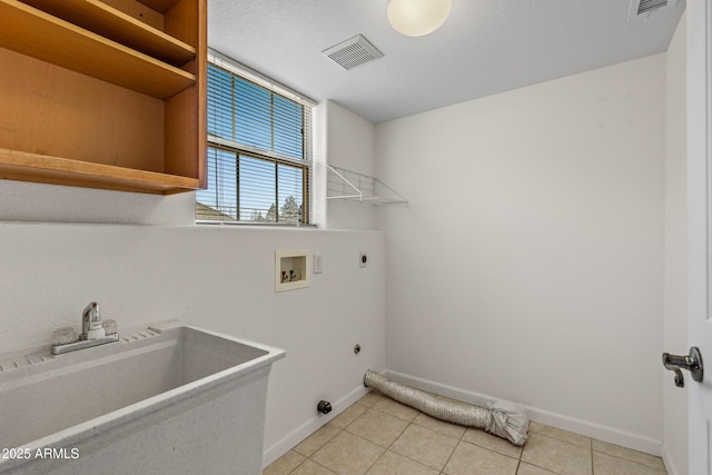 clothes washing area featuring visible vents, hookup for an electric dryer, laundry area, a sink, and washer hookup