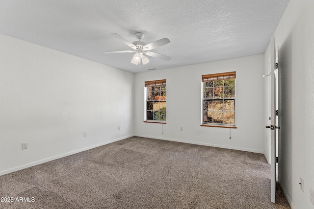 carpeted empty room featuring a ceiling fan, baseboards, and a textured ceiling