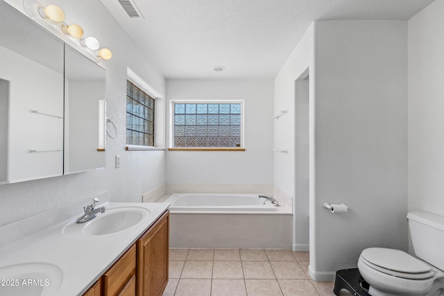 full bath with visible vents, toilet, a sink, tile patterned flooring, and a bath