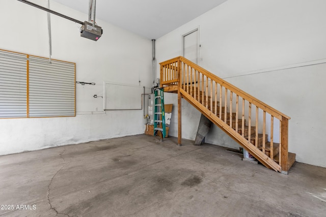 garage with gas water heater and a garage door opener