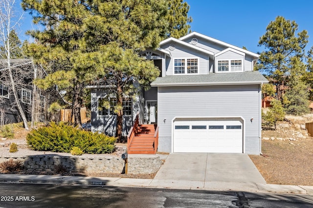 traditional-style house with an attached garage, driveway, roof with shingles, and fence