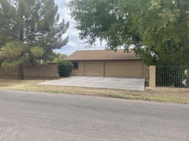 garage with driveway and fence