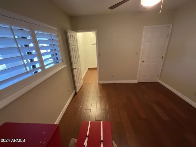 interior space with wood finished floors and baseboards