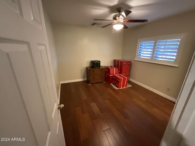 interior space featuring visible vents, ceiling fan, baseboards, and wood finished floors