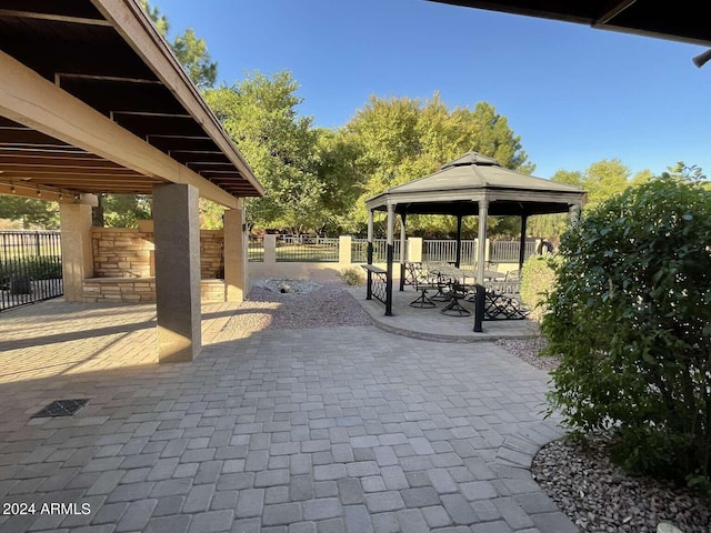 view of property's community with a patio, a gazebo, and fence