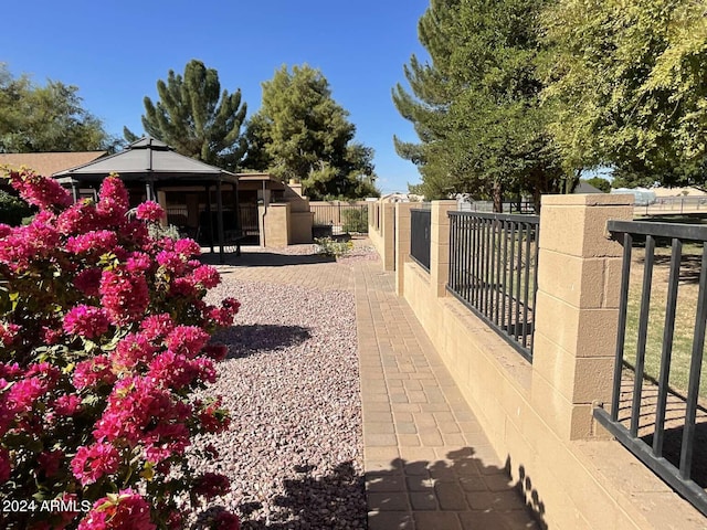 exterior space with a gate, fence, and a gazebo