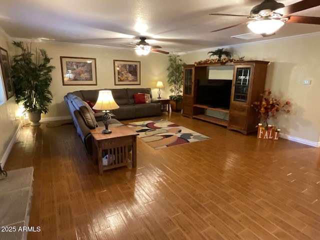 living area featuring ornamental molding, a ceiling fan, and wood finished floors