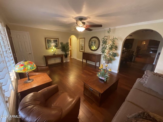 living area featuring crown molding, arched walkways, and wood finished floors