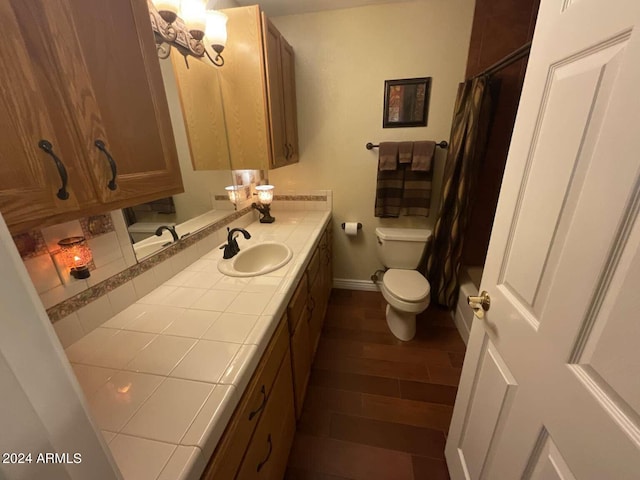 bathroom with wood finished floors, vanity, toilet, and a shower with curtain