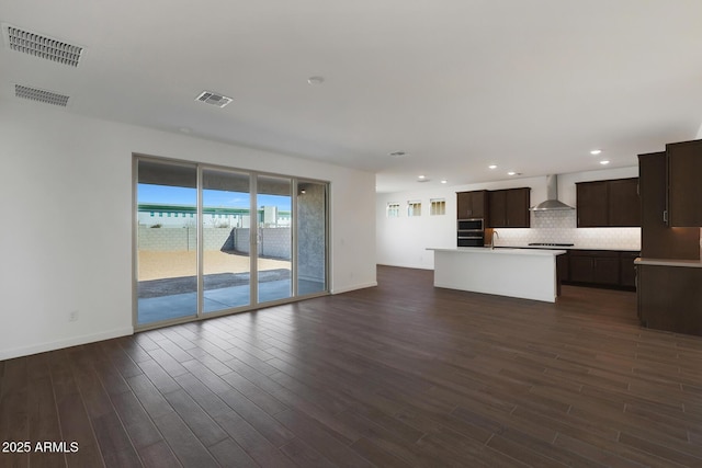 unfurnished living room featuring dark hardwood / wood-style flooring and sink