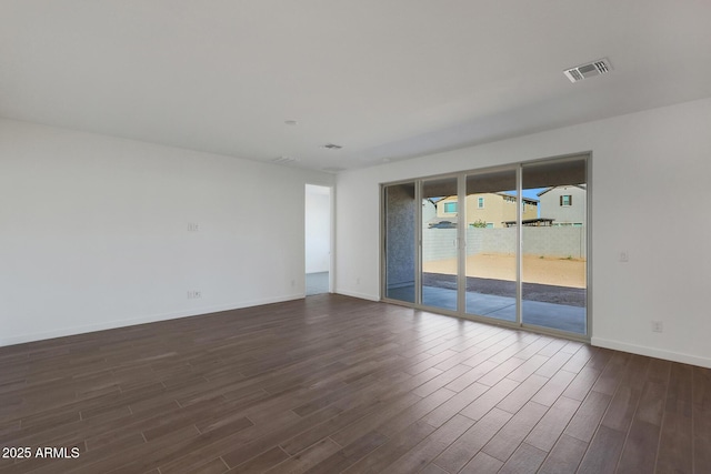 spare room with dark hardwood / wood-style floors