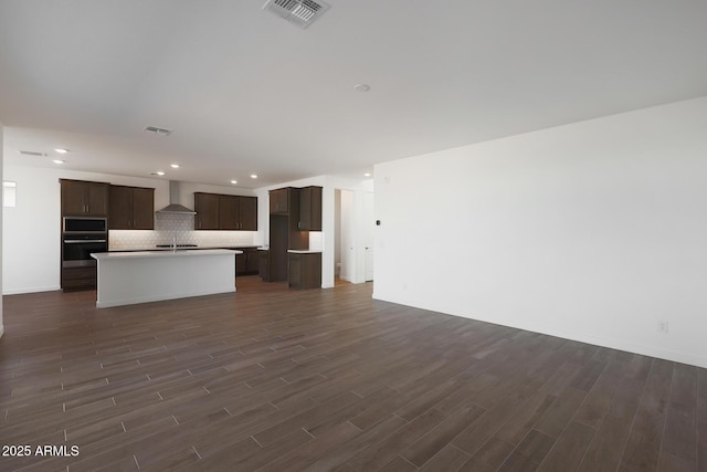 unfurnished living room featuring dark hardwood / wood-style flooring and sink