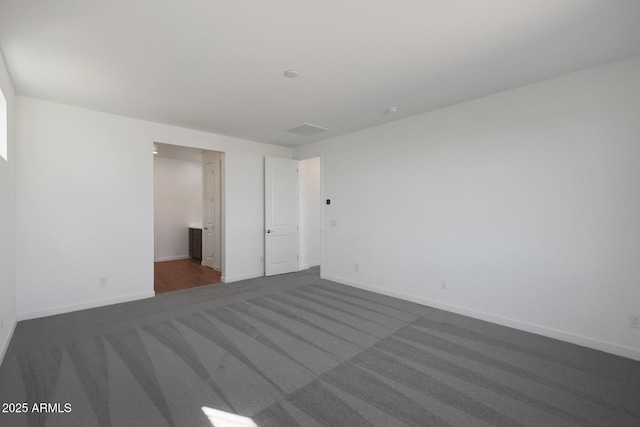 unfurnished bedroom featuring dark colored carpet