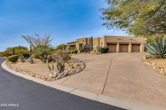 pueblo-style home featuring a garage