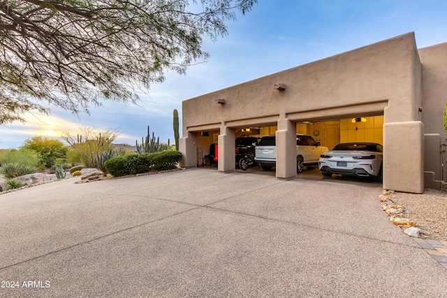 property exterior at dusk featuring a garage