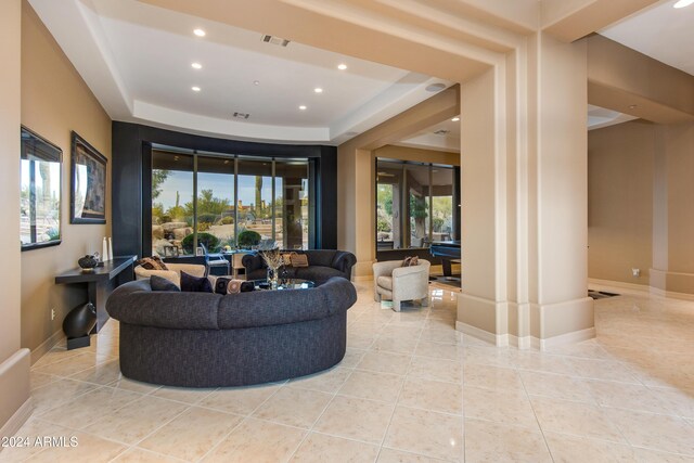 tiled living room with a tray ceiling and billiards