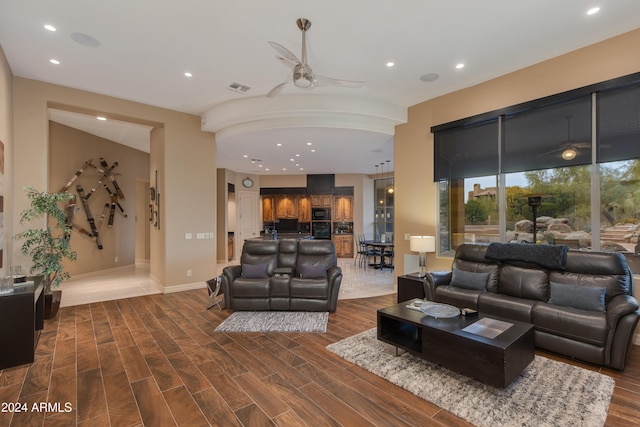 living room featuring dark hardwood / wood-style flooring and ceiling fan