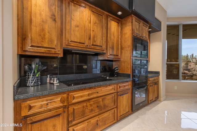 kitchen with black appliances, decorative backsplash, light tile patterned flooring, and extractor fan