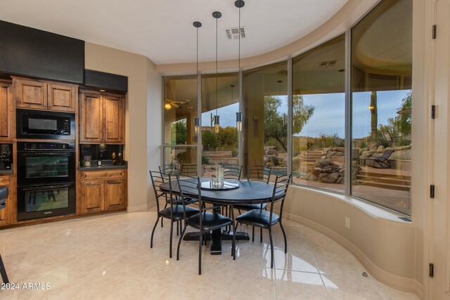 dining room with ceiling fan and light tile patterned flooring