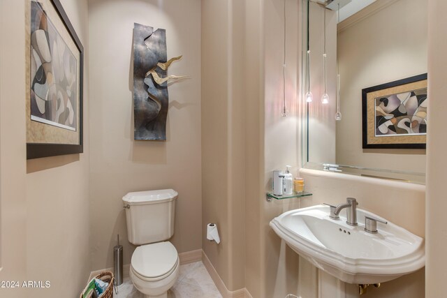 bathroom featuring sink, tile patterned flooring, and toilet