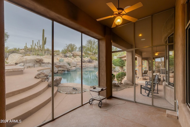 unfurnished sunroom featuring ceiling fan