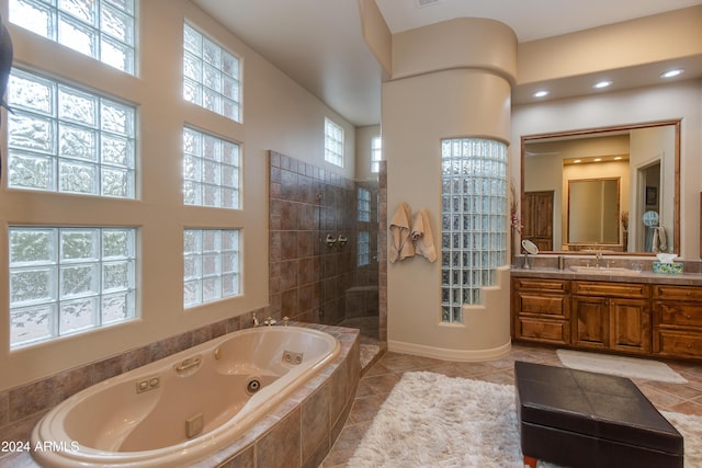 bathroom featuring shower with separate bathtub, vanity, tile patterned floors, and a wealth of natural light