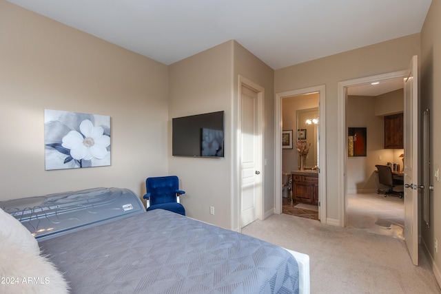 bedroom featuring connected bathroom and light colored carpet