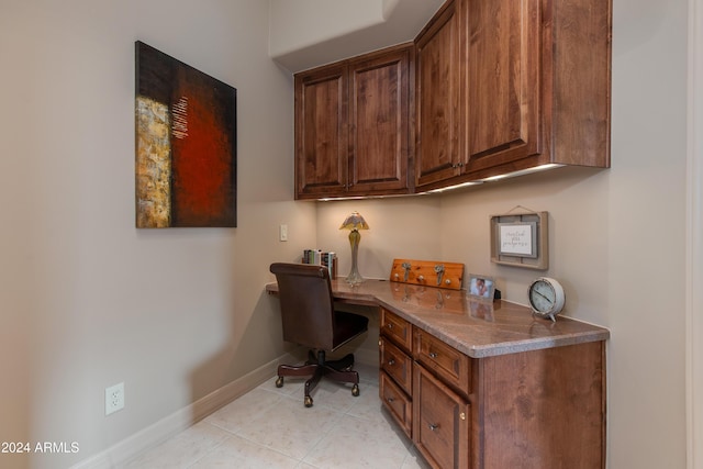 home office featuring light tile patterned floors and built in desk