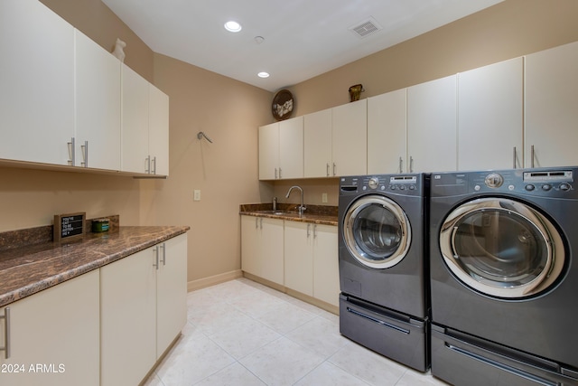 laundry area featuring cabinets, independent washer and dryer, sink, and light tile patterned floors