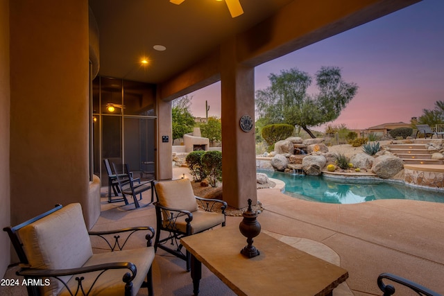 patio terrace at dusk with an outdoor stone fireplace