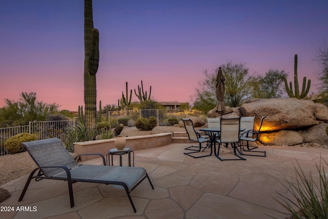 view of patio terrace at dusk