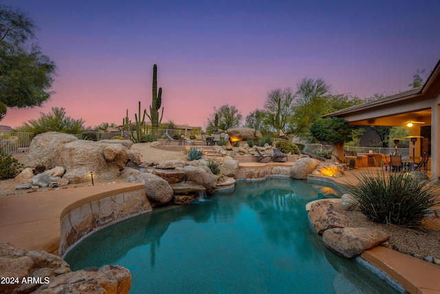 view of pool at dusk