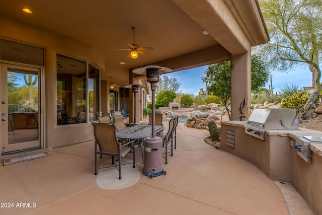 view of patio with area for grilling, ceiling fan, and a swimming pool