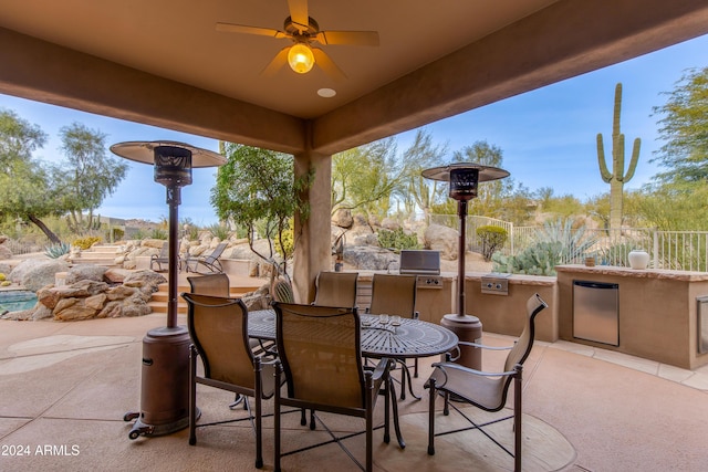 view of patio with ceiling fan and a grill