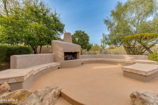 view of patio with an outdoor fireplace