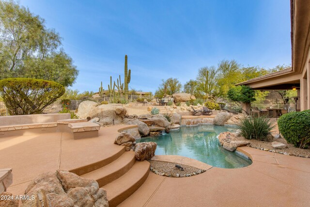 view of swimming pool with a patio