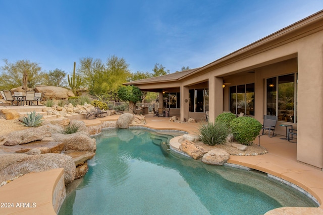 view of pool featuring pool water feature and a patio area