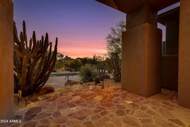 view of patio terrace at dusk