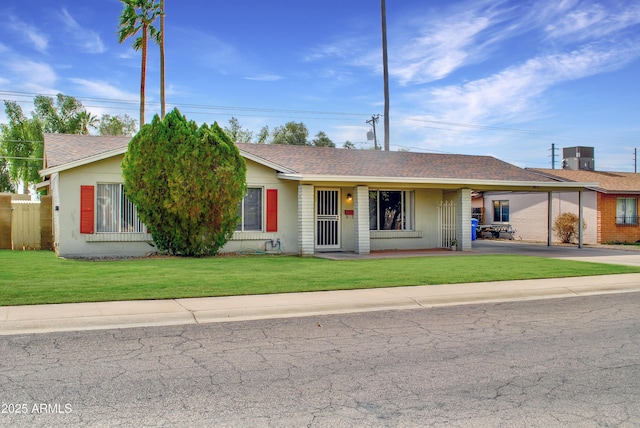 ranch-style home with a front lawn and central air condition unit