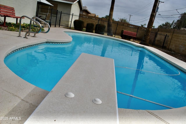 view of pool featuring a patio and a diving board