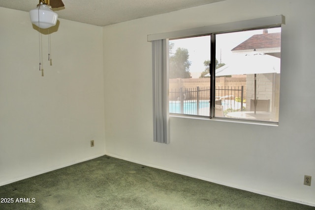 carpeted spare room with a textured ceiling