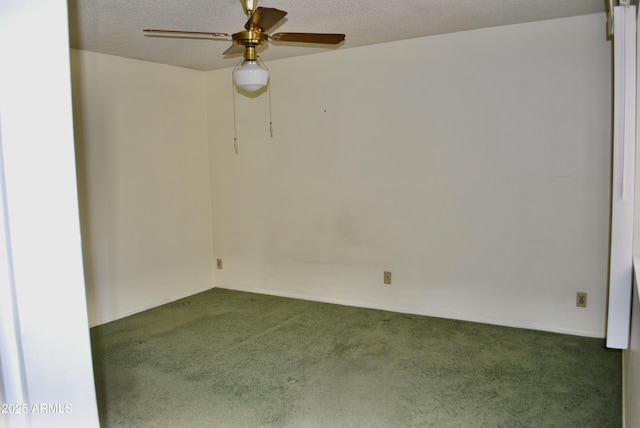 unfurnished room featuring ceiling fan, dark carpet, and a textured ceiling