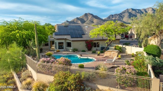 10875 E Mirasol Cir, Scottsdale, AZ 85255 - rear view of property featuring a tile roof, a patio area, a fenced backyard, roof mounted solar panels, and stucco siding