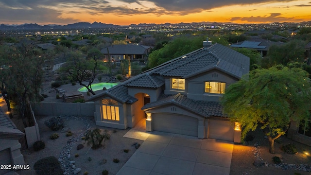 10875 E Mirasol Cir, Scottsdale, AZ 85255 - view of front of home featuring a tile roof, a mountain view, a fenced backyard, concrete driveway, and stucco siding