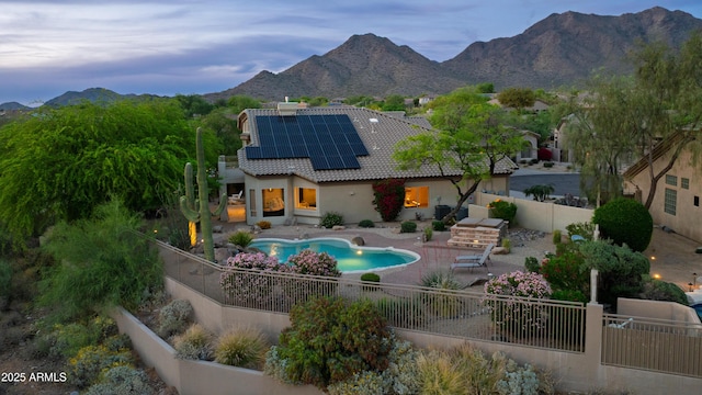 10875 E Mirasol Cir, Scottsdale, AZ 85255 - back of house featuring a fenced backyard, roof mounted solar panels, a patio area, a mountain view, and a tile roof