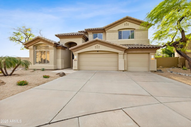 10875 E Mirasol Cir, Scottsdale, AZ 85255 - mediterranean / spanish-style house featuring a garage, stucco siding, driveway, and a tile roof