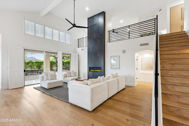 10875 E Mirasol Cir, Scottsdale, AZ 85255 - living area featuring a ceiling fan, arched walkways, high vaulted ceiling, baseboards, and beamed ceiling