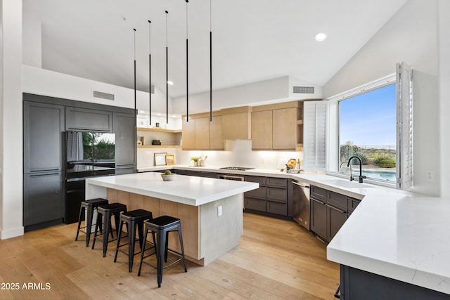 10875 E Mirasol Cir, Scottsdale, AZ 85255 - kitchen featuring open shelves, a sink, dishwasher, a kitchen bar, and visible vents