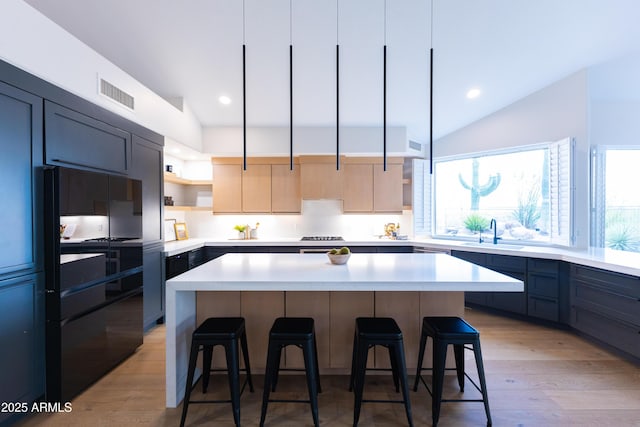 10875 E Mirasol Cir, Scottsdale, AZ 85255 - kitchen with a kitchen bar, open shelves, a sink, light countertops, and lofted ceiling